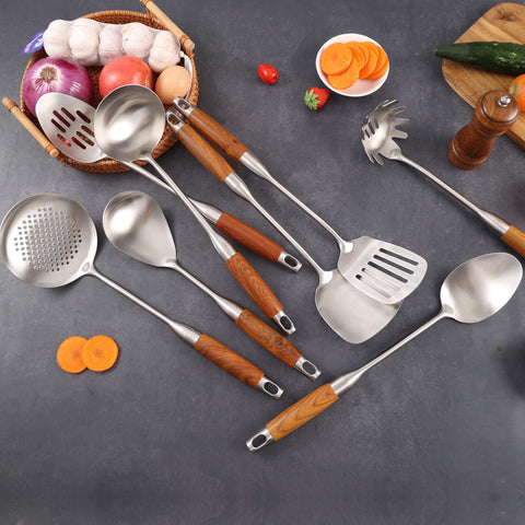 Standcn utensils hung on kitchen rail displaying decorative storage and easy access