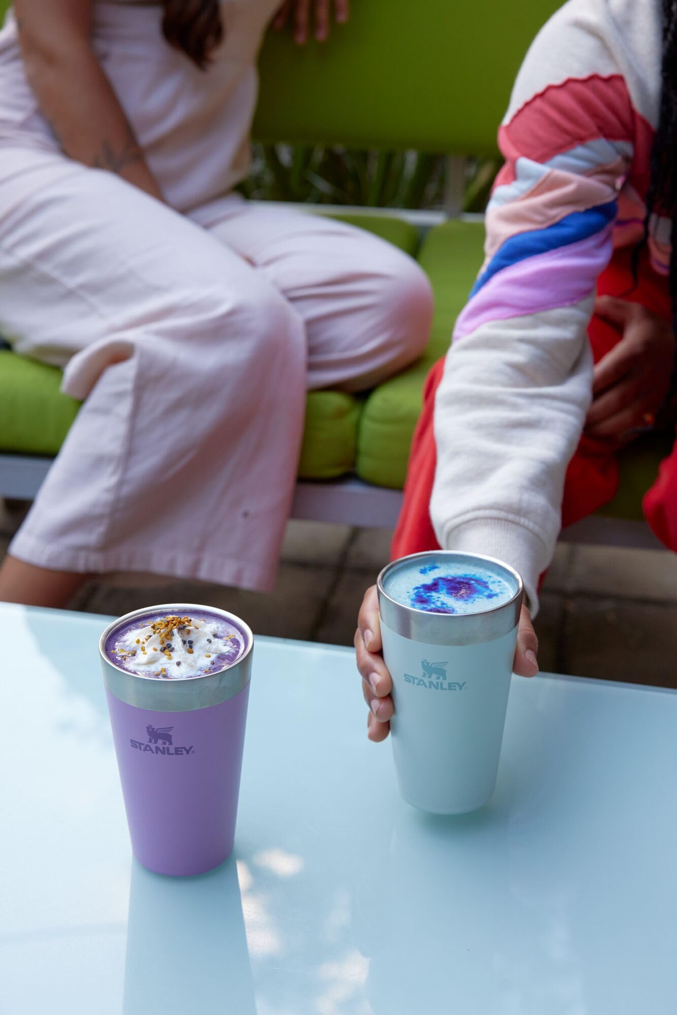 Hand holding STANLEY pint with beer showing outdoor use and temperature retention benefit