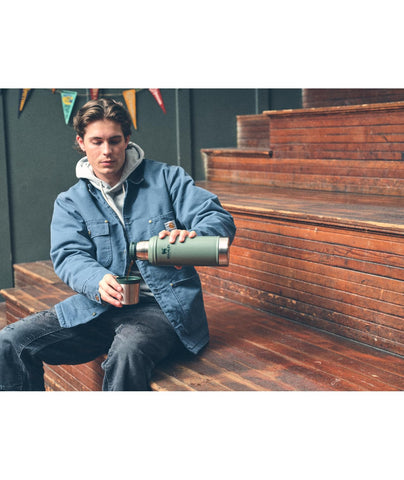 STANLEY bottle on a campsite table illustrating rugged use and dependable temperature retention