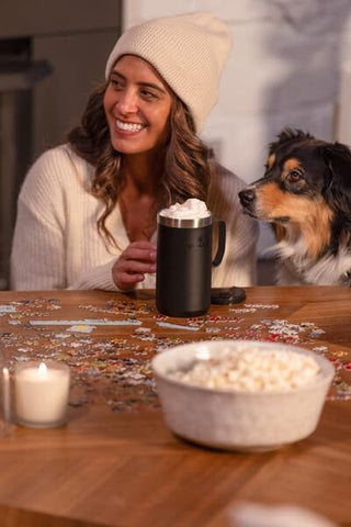 STANLEY mug next to a smartphone for scale, illustrating the 24oz capacity and portability