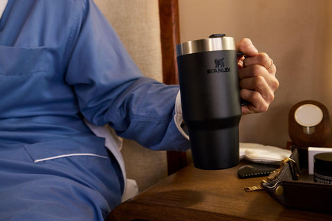 STANLEY mug in car cup holder demonstrating travel fit and secure placement benefit