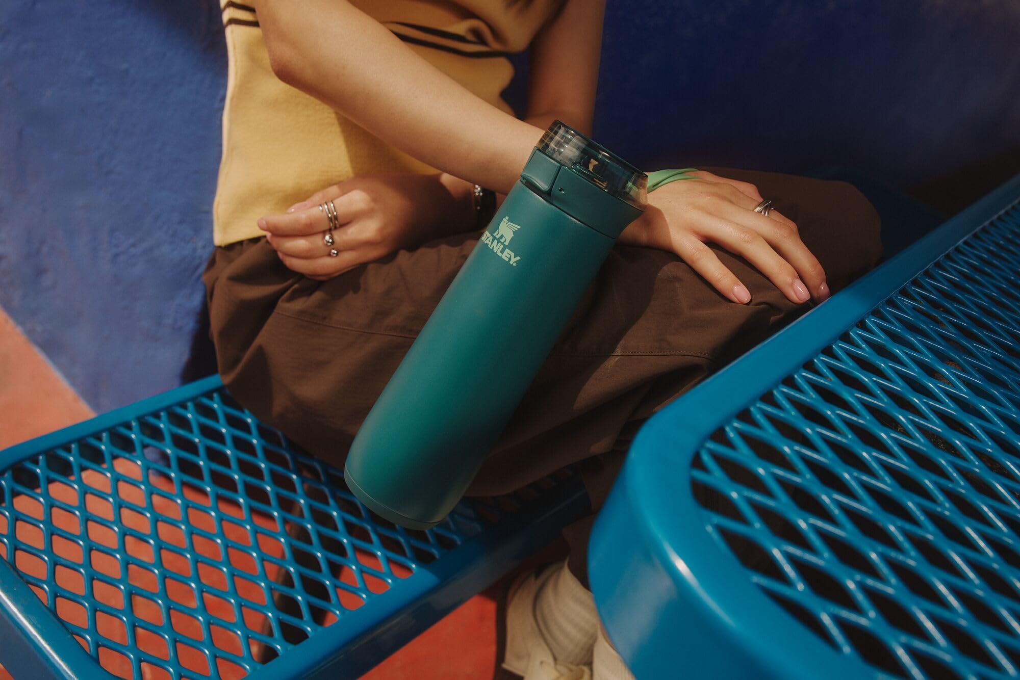 STANLEY bottle seated in car cupholder for hands-free travel benefit