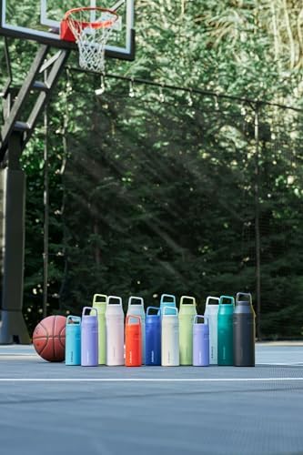 STANLEY bottle on a beach towel showing portable hydration for outdoor adventures
