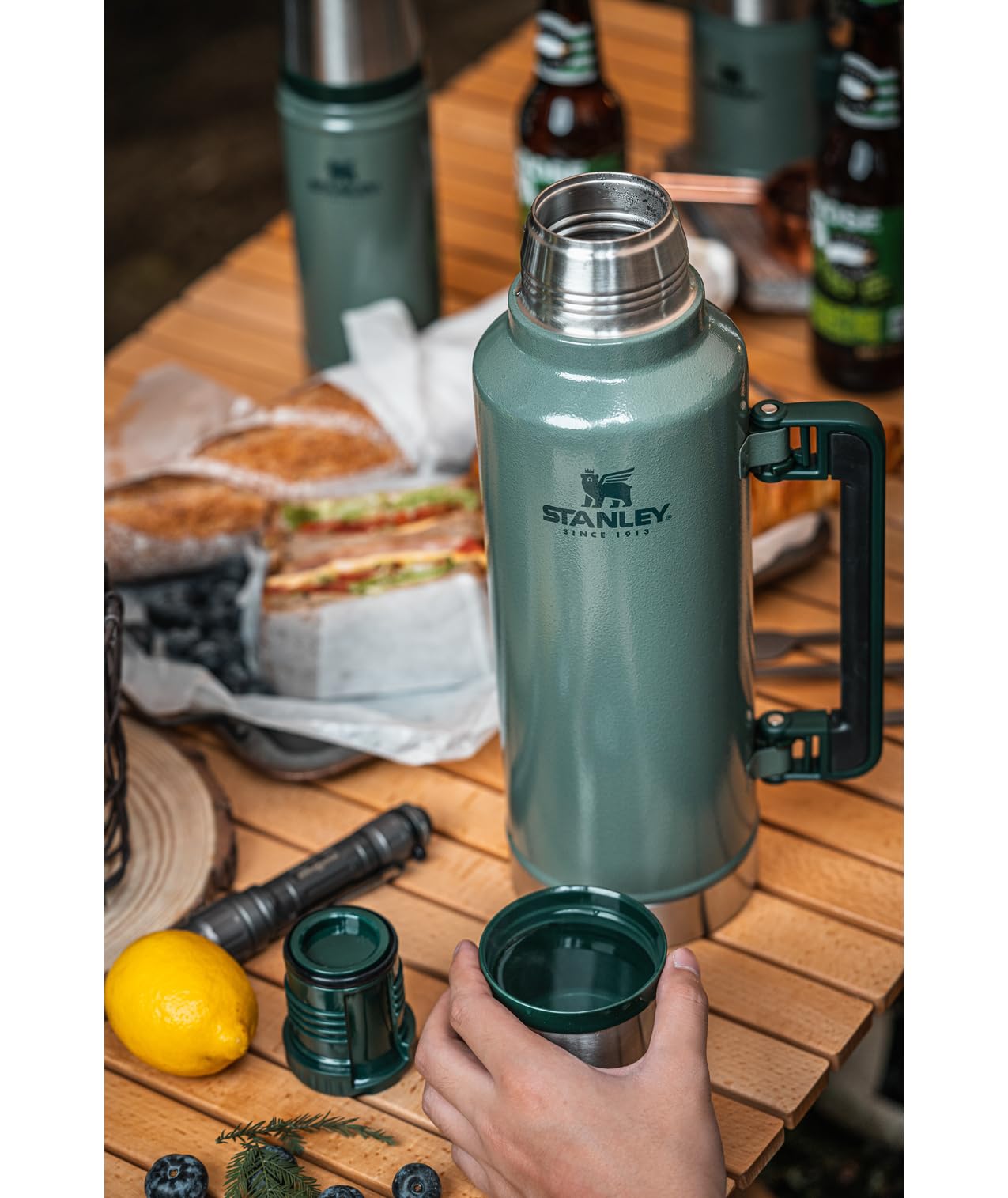 Stanley lifestyle camping scene showing bottle on campsite keeping drinks ready benefit