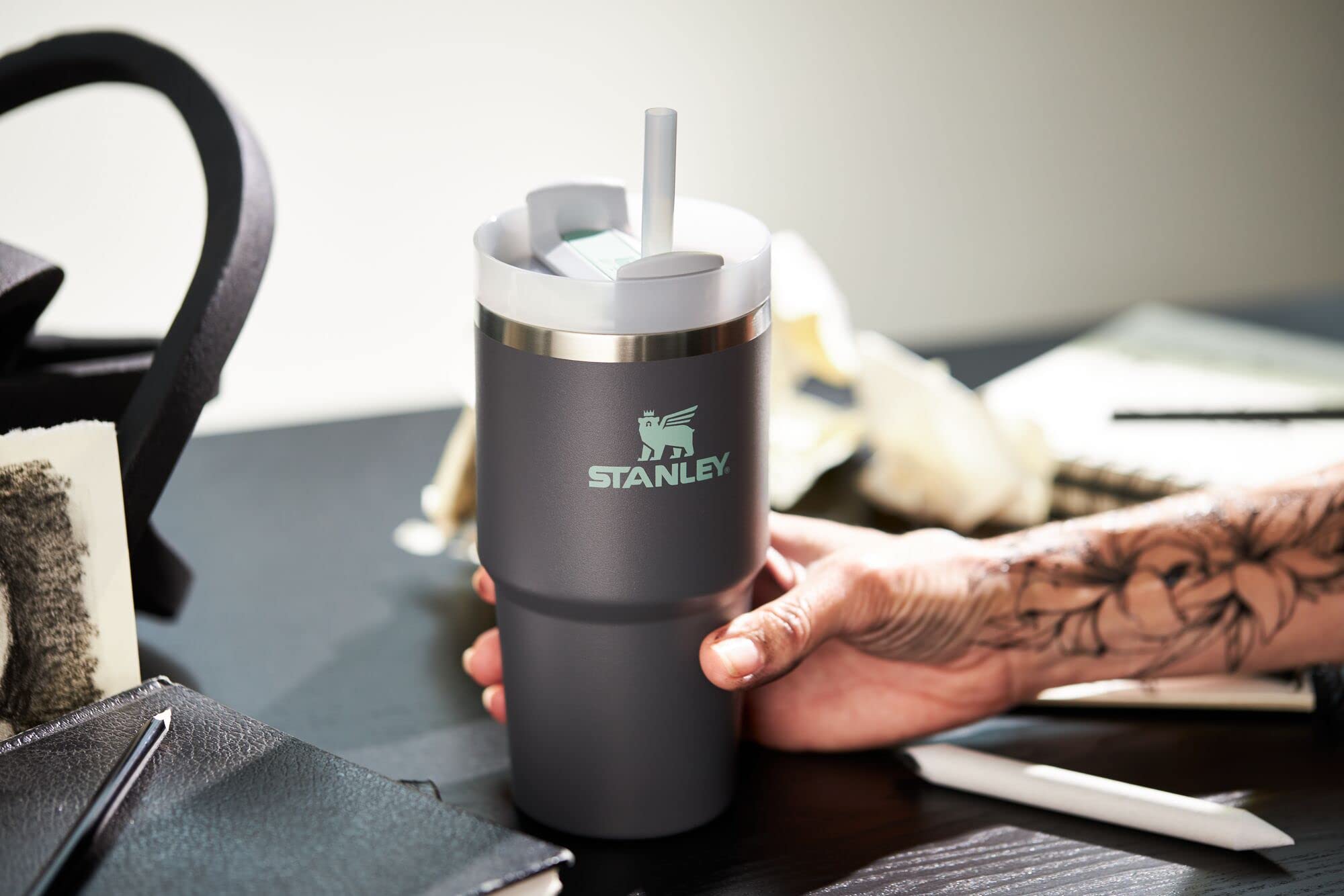 STANLEY held in hand for size comparison showing 20 oz capacity and comfortable grip for easy carrying