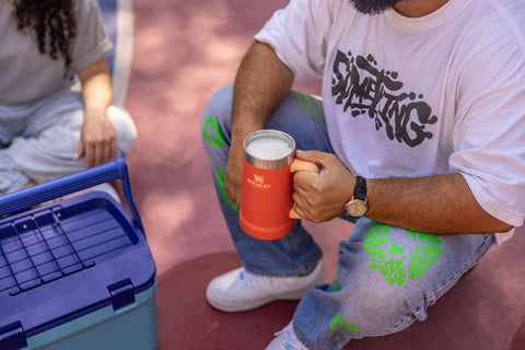 STANLEY stein beside two beer cans showing true size and refill-reducing capacity