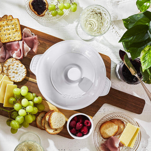 STAUB brie baker on styled dining table enhancing presentation and warmth