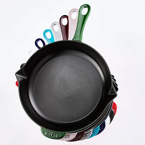 Staub pan next to utensils for size comparison showing practical kitchen fit