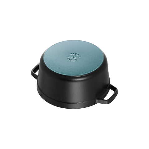 STAUB brass-plated knob and lid edge close-up indicating heat-resistant quality