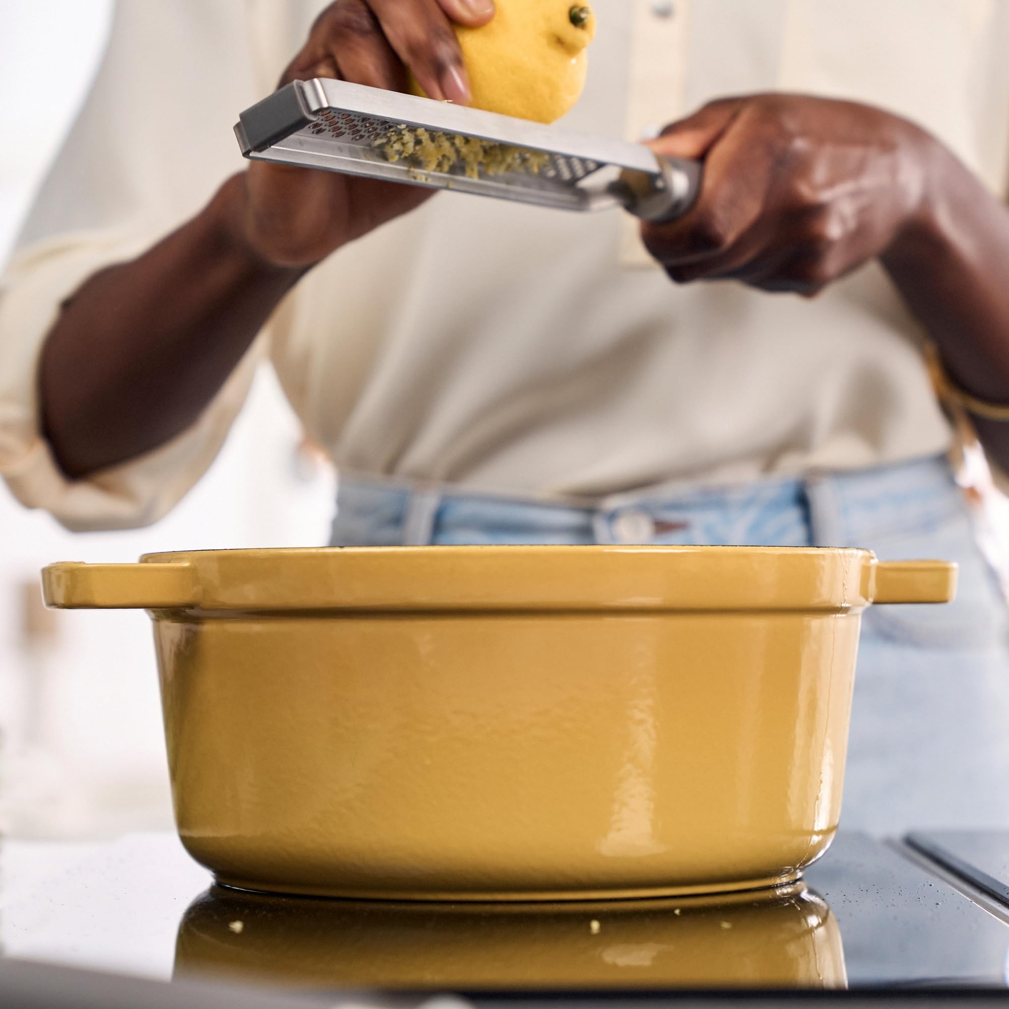 Staub cocotte on stovetop searing meat for even heat and flavor