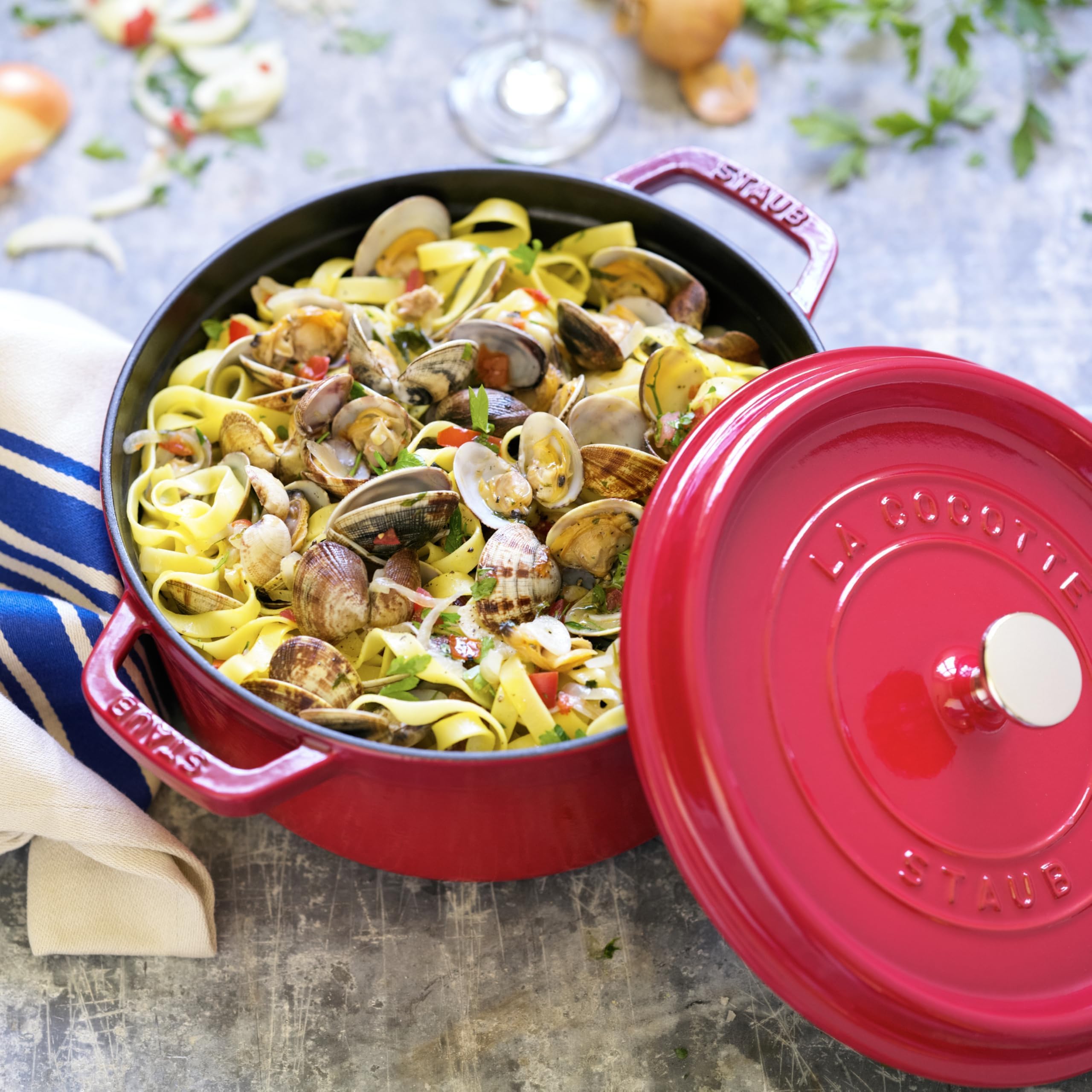 Staub cocotte next to apples to show 4-quart scale and serving capacity