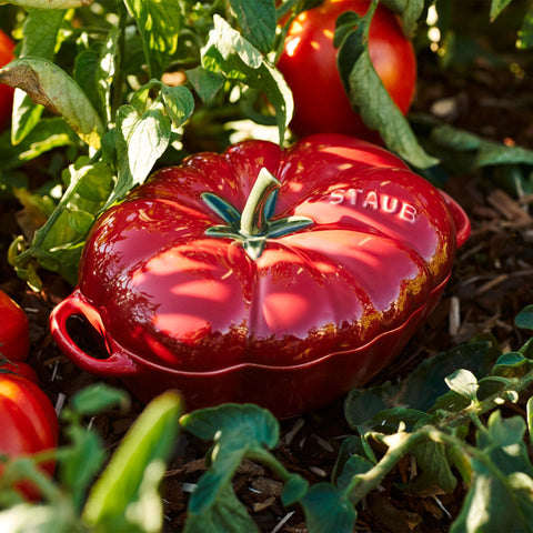 Staub tomato cocotte top lid detail highlighting stem handle, easy lifting benefit