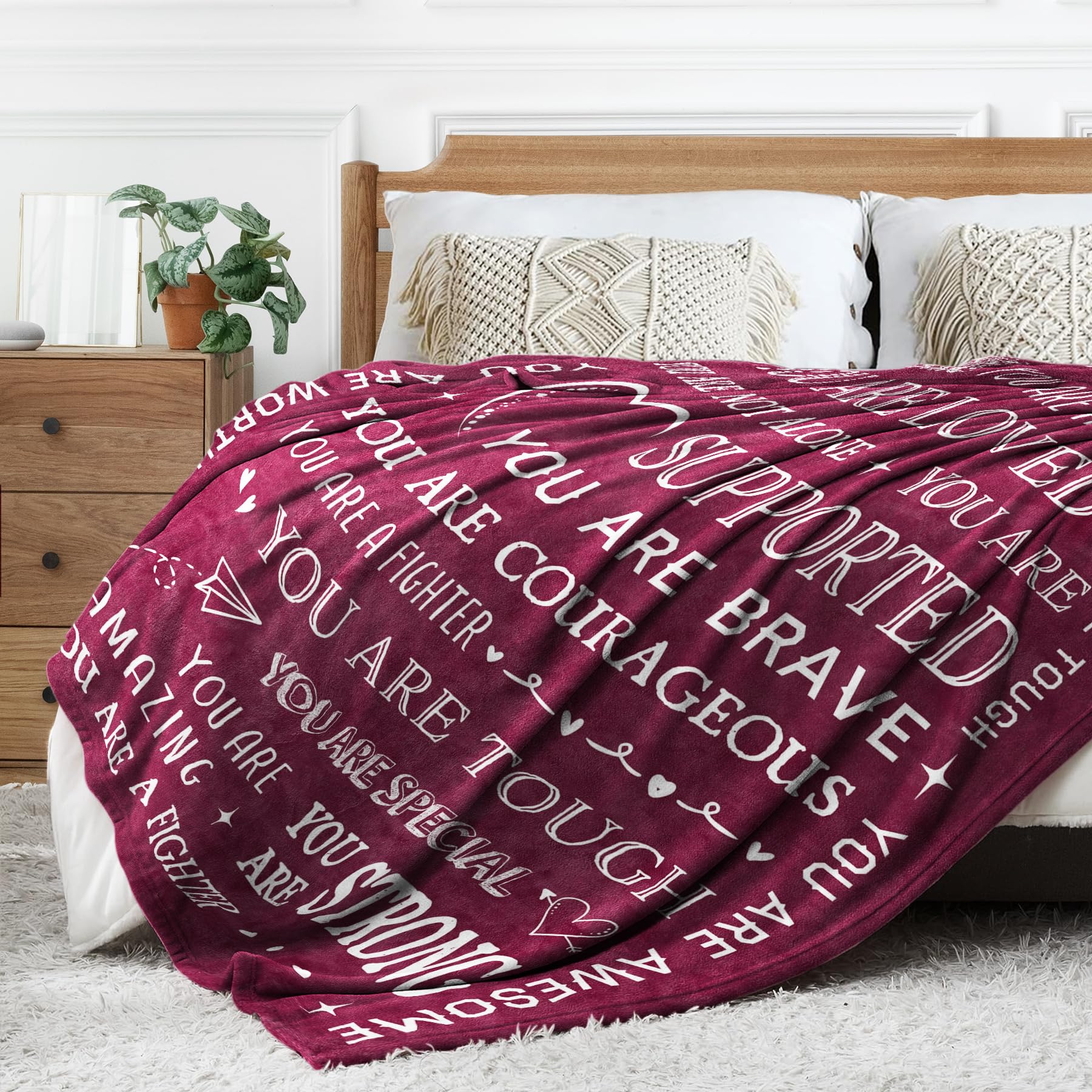 SteadStyle folded blanket beside a book showing compact travel-friendly size