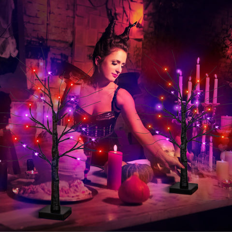 StzMamil mantel display with two trees creating atmospheric Halloween decor