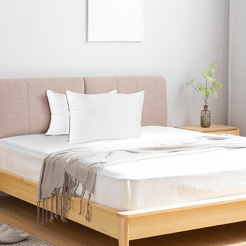 Subrcamos four pillows stacked on bed showing matching set for multi-bed setup