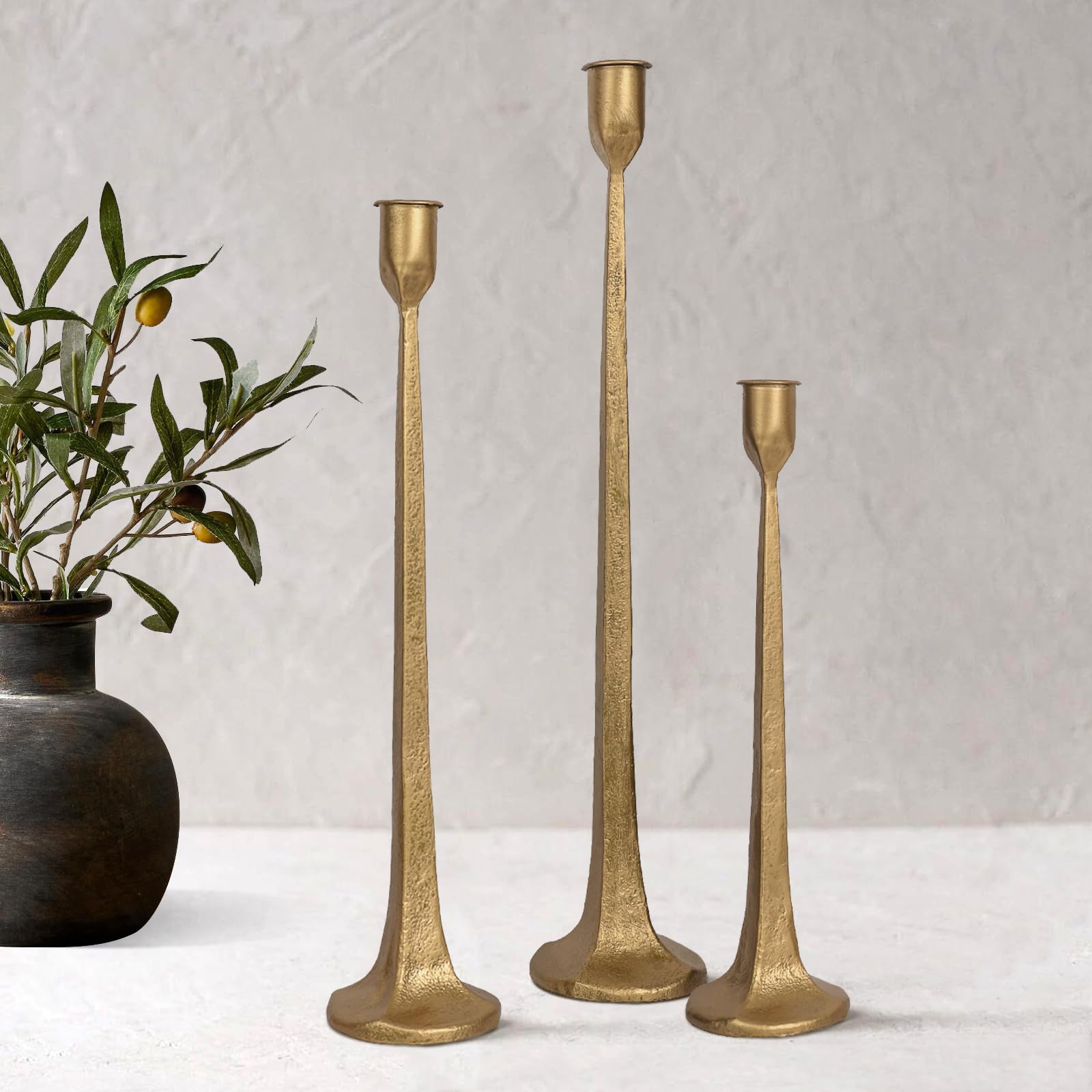 SUJUN front view of three cast iron candlesticks showing elegant silhouette and balance