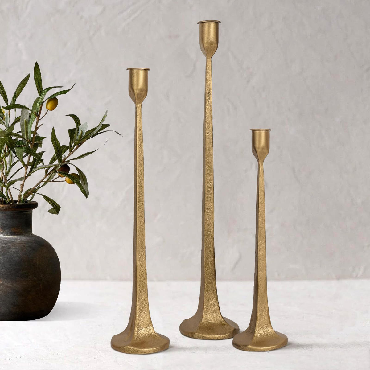 SUJUN front view of three cast iron candlesticks showing elegant silhouette and balance
