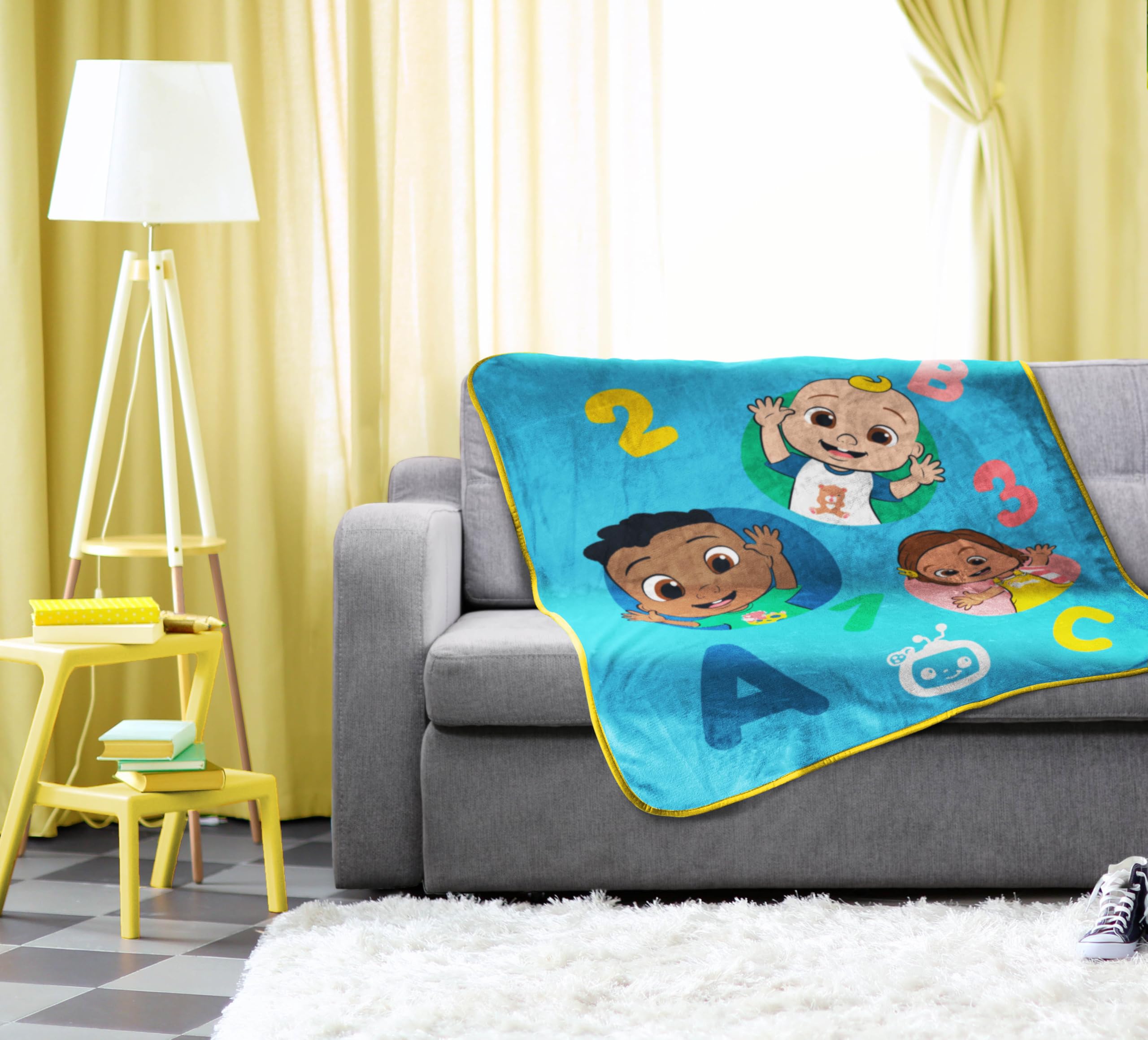 Sunny Side Up CoComelon blanket styled in bedroom adding cheerful décor