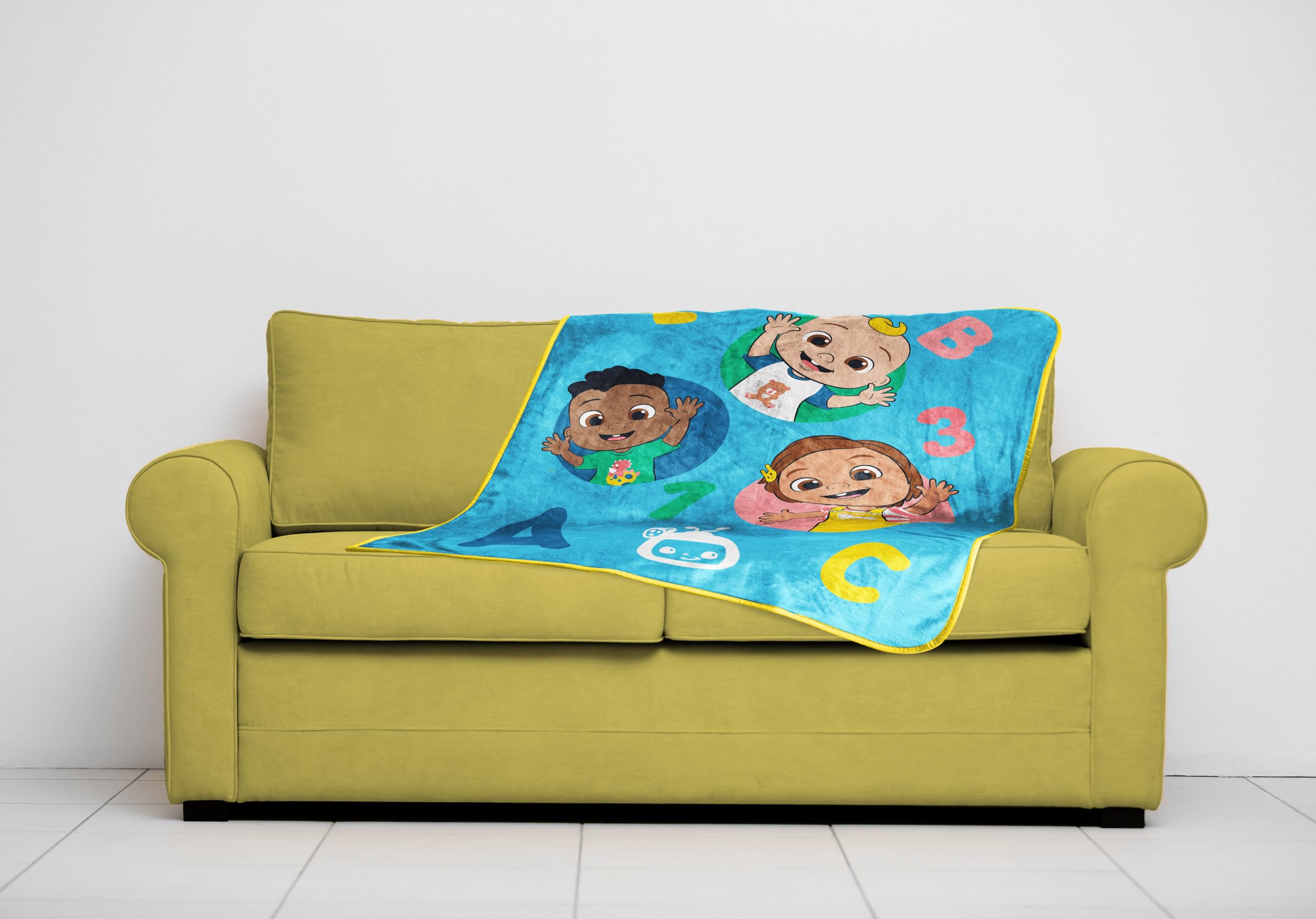 Sunny Side Up CoComelon blanket beside a toddler to show 40x50 inch scale