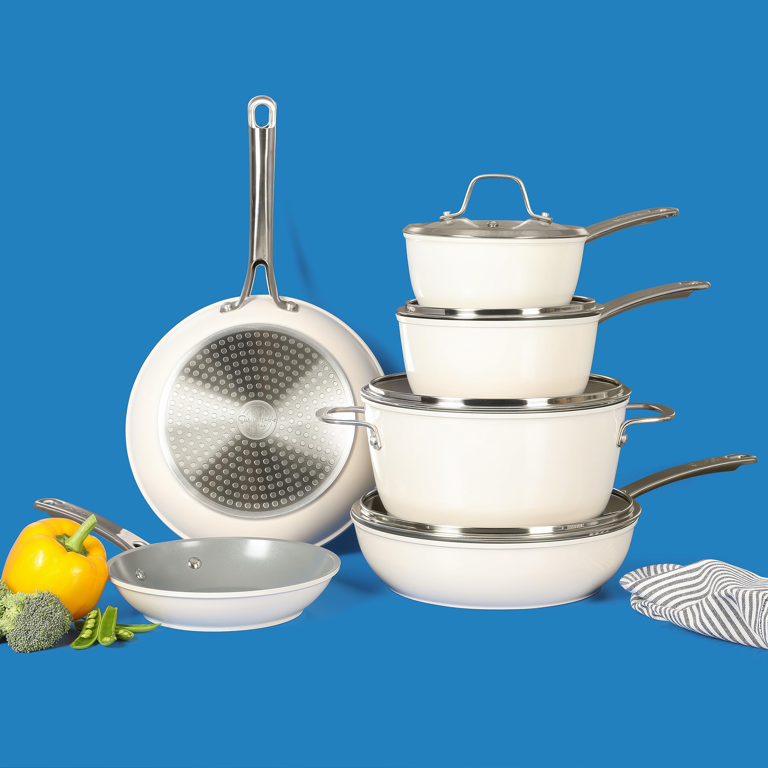Sur La Table cookware displayed in kitchen with finished dishes showing attractive color and entertaining ease