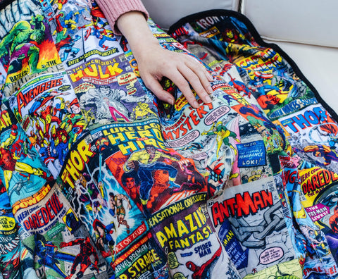 Surreal Entertainment blanket spread on bed creating comic-themed decor and visual impact