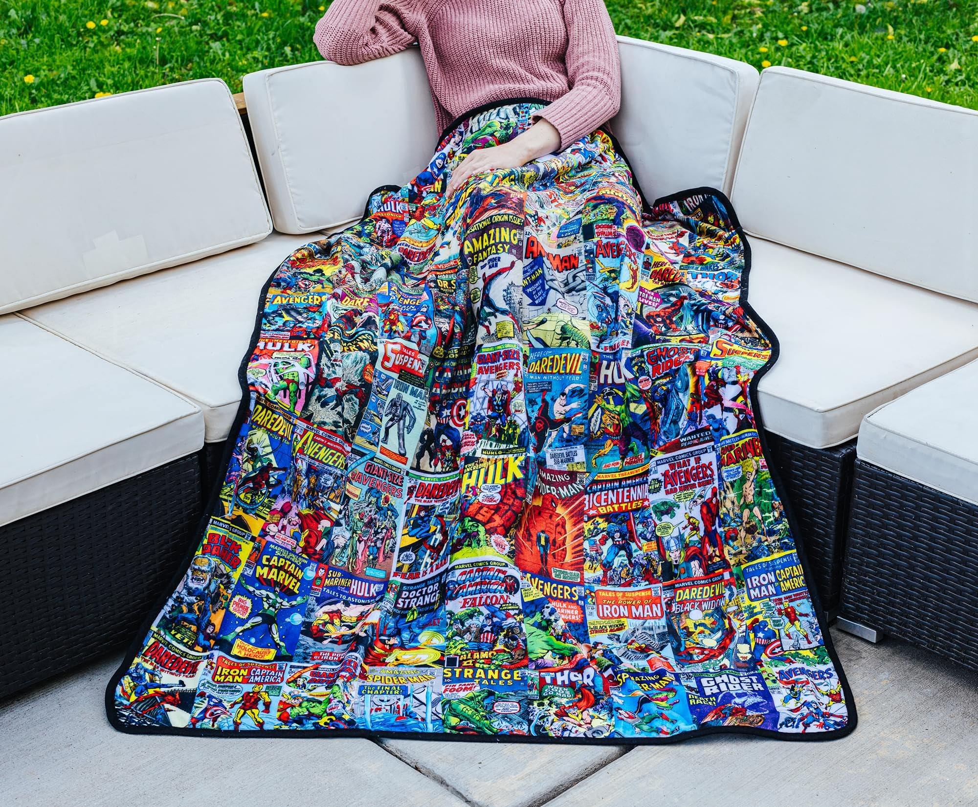 Surreal Entertainment blanket draped on sofa adding Marvel style and cozy seating comfort