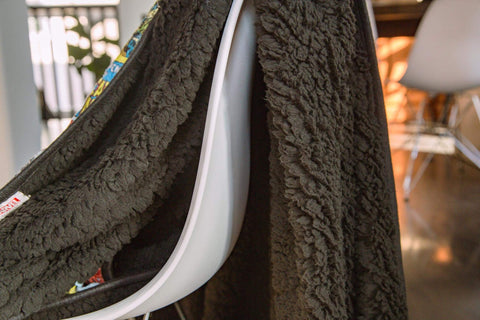 Surreal Entertainment folded blanket in hand for travel, portable and lightweight