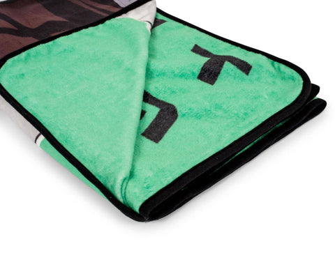 Surreal Entertainment Tanjiro throw draped on sofa providing a warm lounging layer