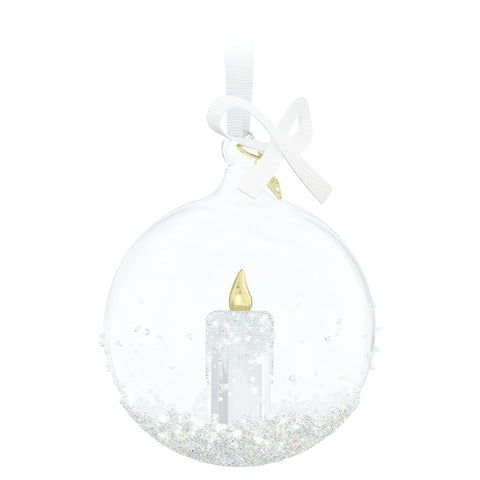 Swarovski internal candle motif close-up with gold-tone flame for warm reflection