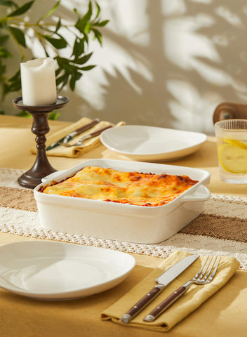 Sweese hands carrying dish to table showing double handles for safe transport