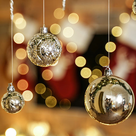 SY CRAFT ornaments hung on a lit tree adding cohesive festive sparkle