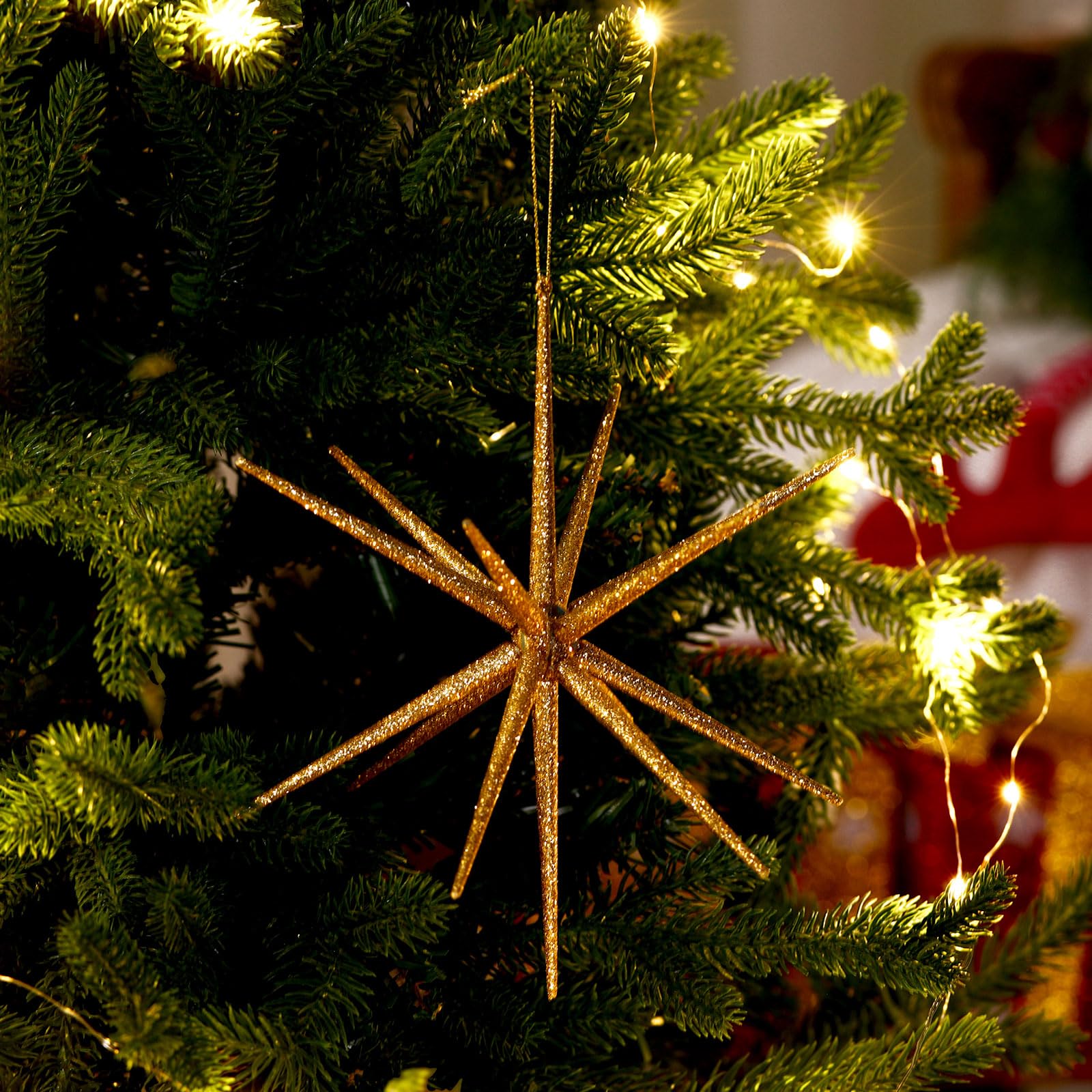 Syhood starburst assembled on Christmas tree adding reflective holiday glow
