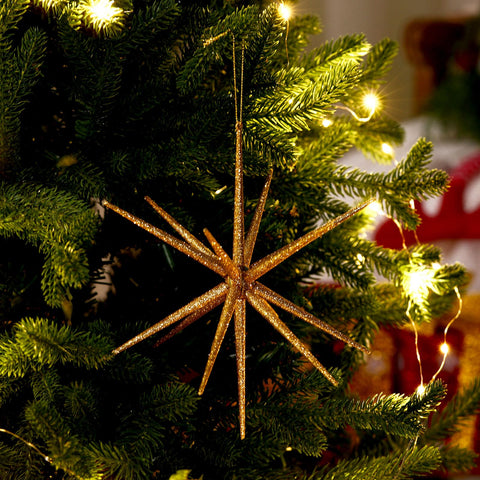 Syhood starburst assembled on Christmas tree adding reflective holiday glow