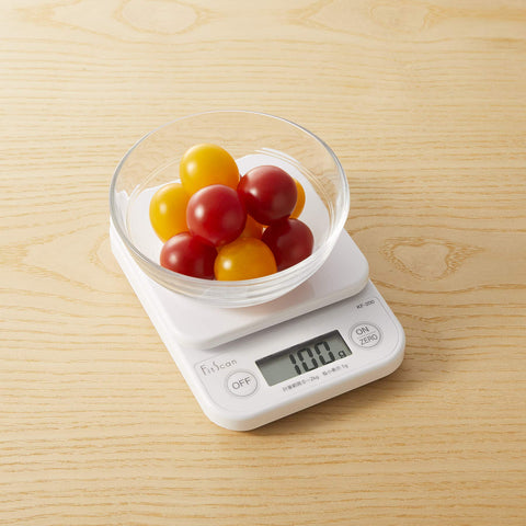 TANITA scale in use with mixing bowl demonstrating accurate ingredient weighing during prep