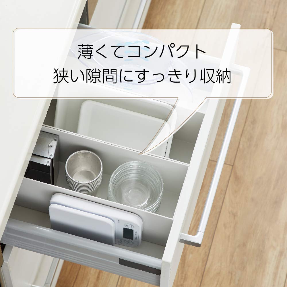 TANITA size comparison beside a coffee mug showing compact footprint and space-saving benefit