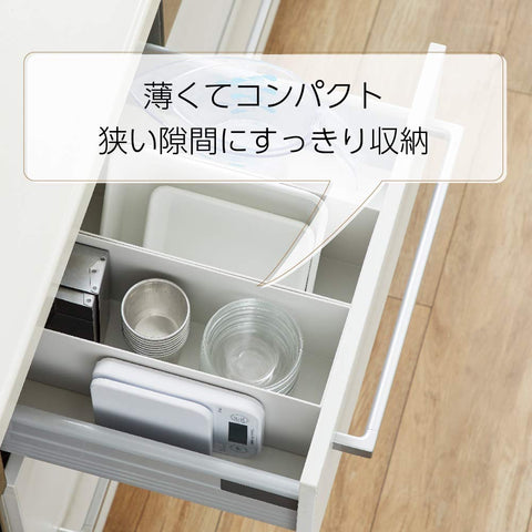 TANITA size comparison beside a coffee mug showing compact footprint and space-saving benefit