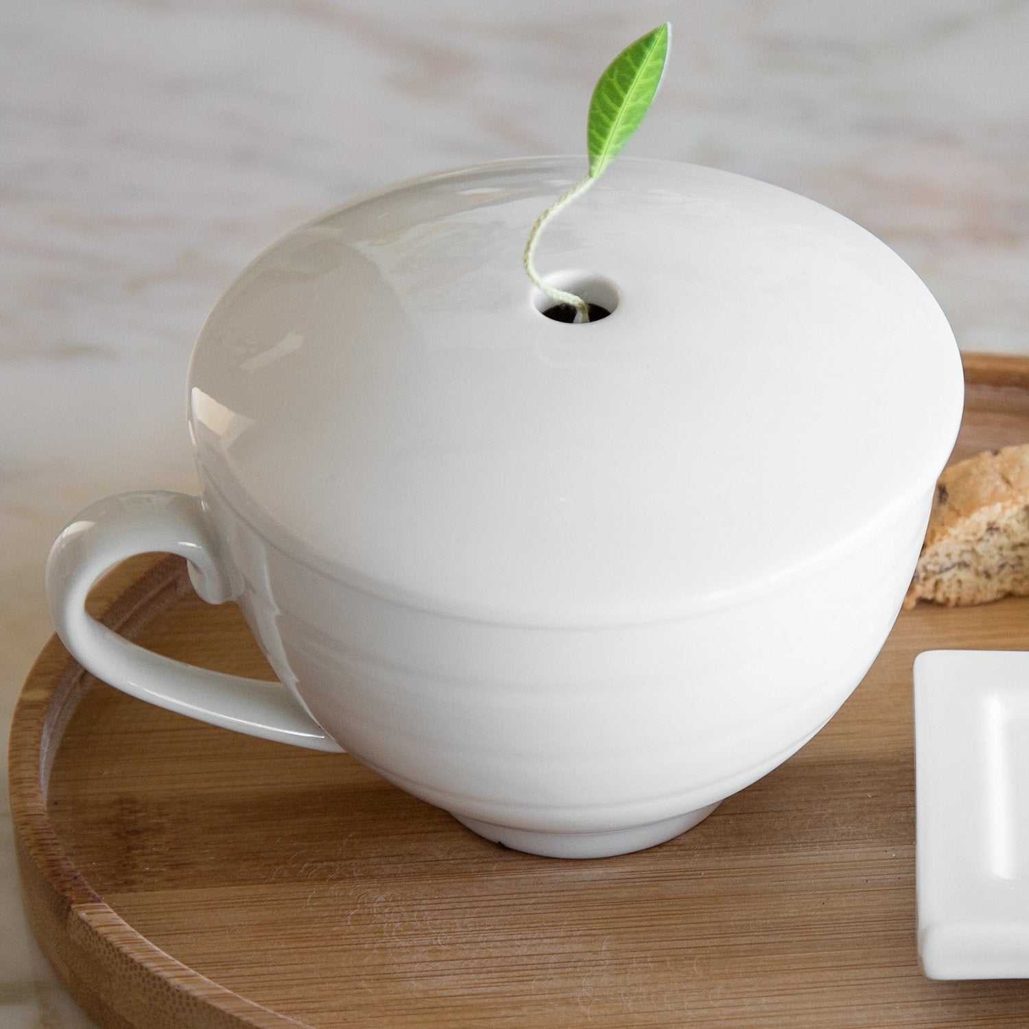 Tea Forte café cup on a tray in a cozy table setting, creates a refined ritual and welcoming vibe