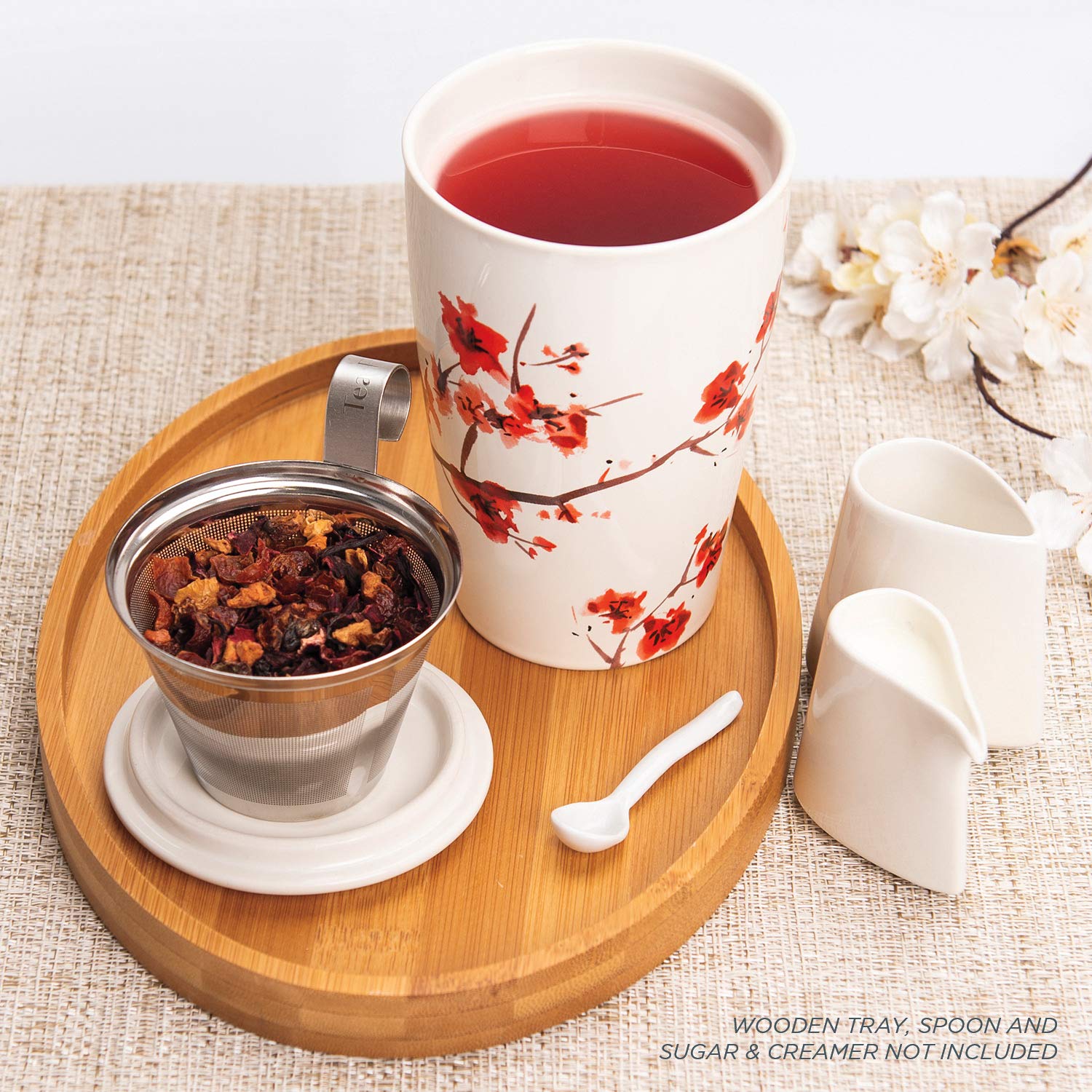 Tea Forte Kati cup beside a hand to show 12 oz size and portable convenience