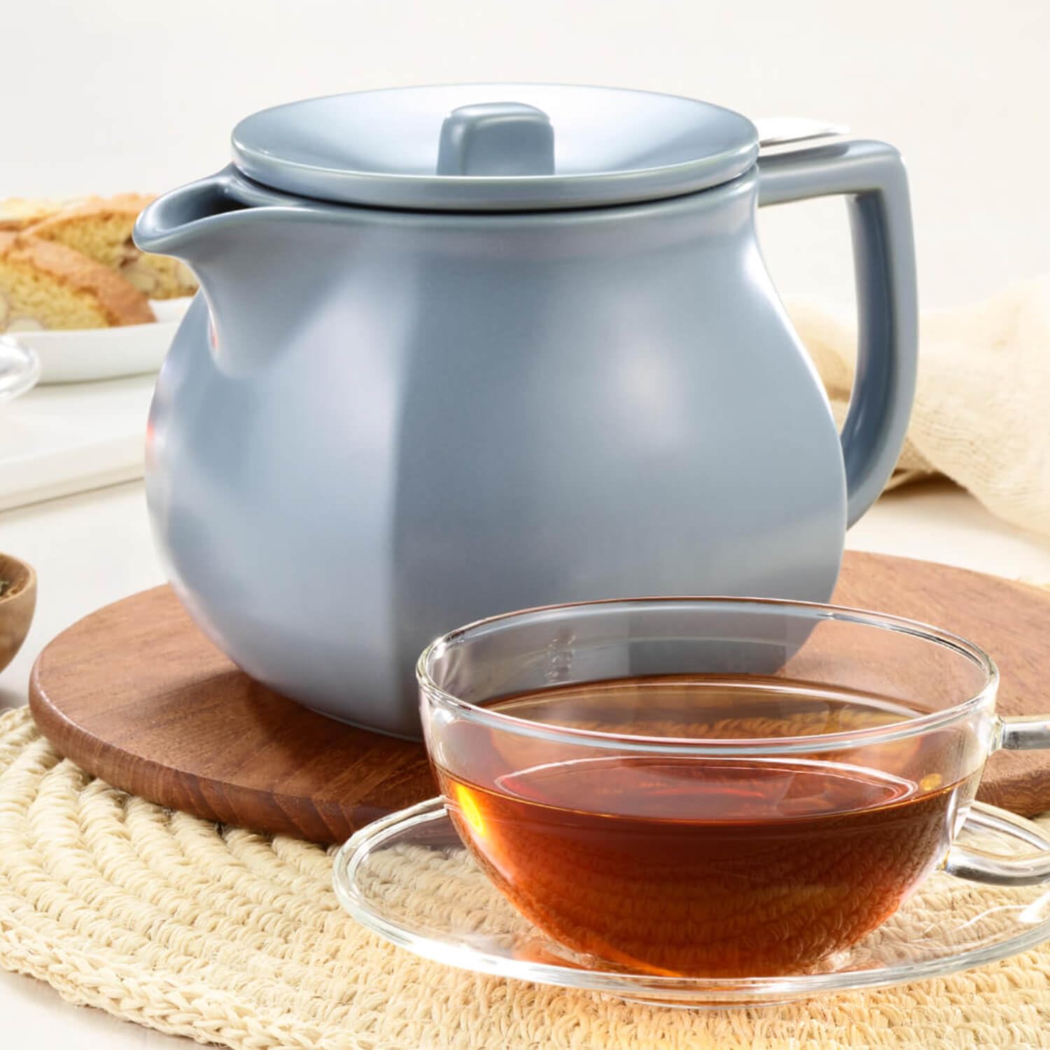 Tea Forte teapot next to cup showing 24 oz size for sharing