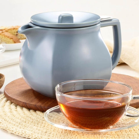 Tea Forte teapot next to cup showing 24 oz size for sharing
