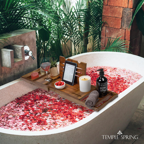 Temple Spring open on a bathtub holding drink and spa items for convenience