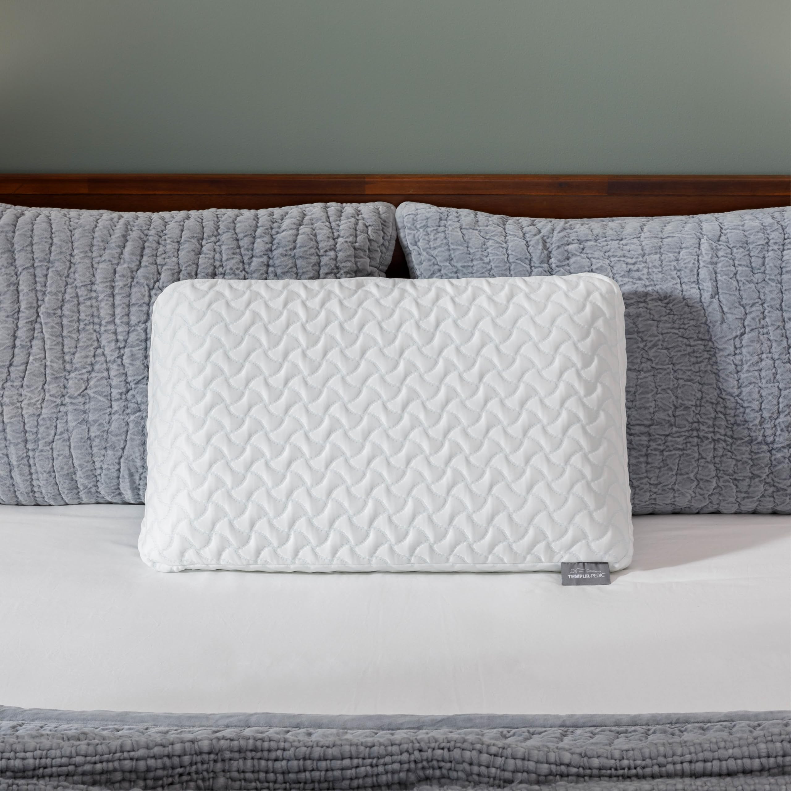 Tempur-Pedic head resting on pillow, demonstrates cradling support and comfort