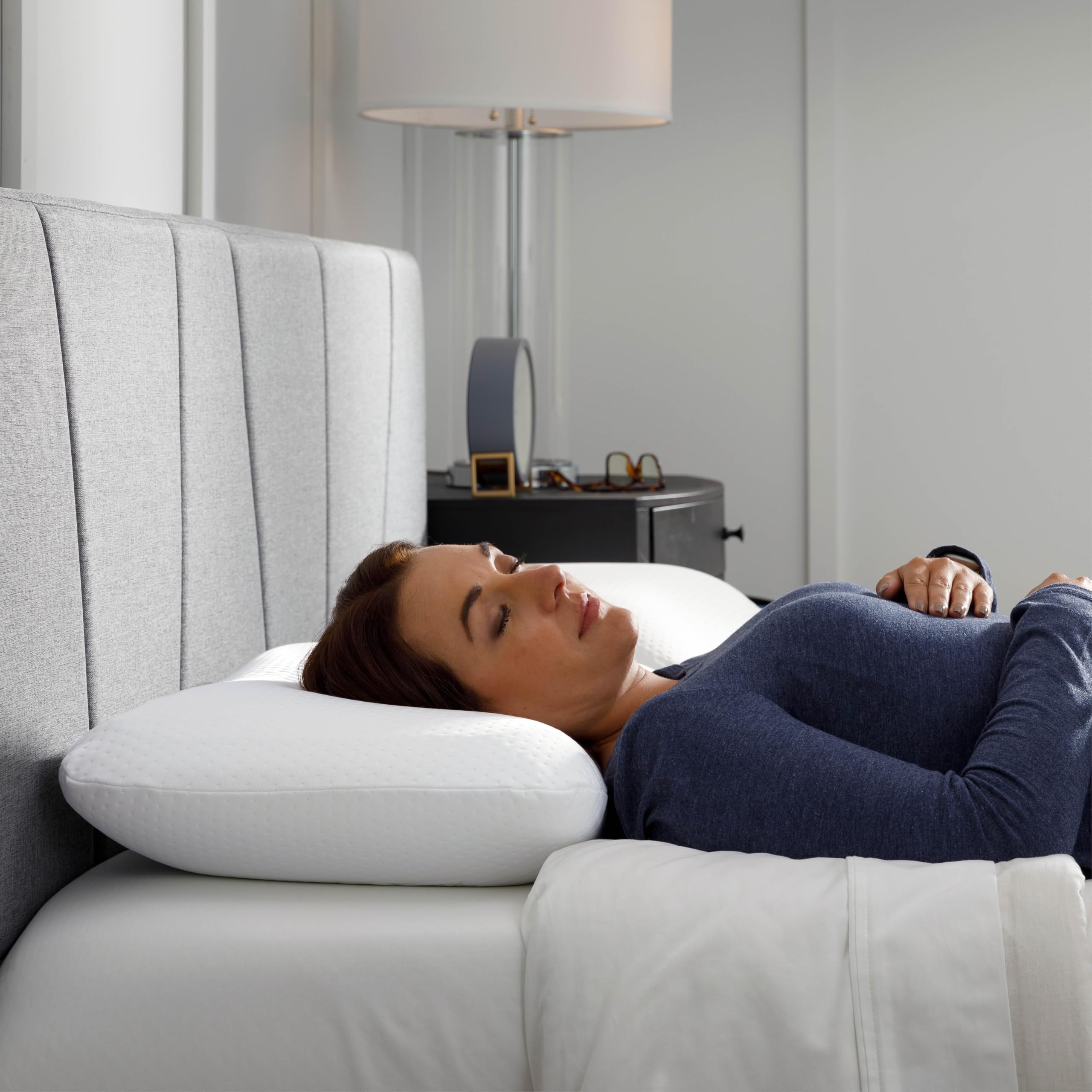 Tempur-Pedic pillow held in hand showing size and scale for purchasing confidence