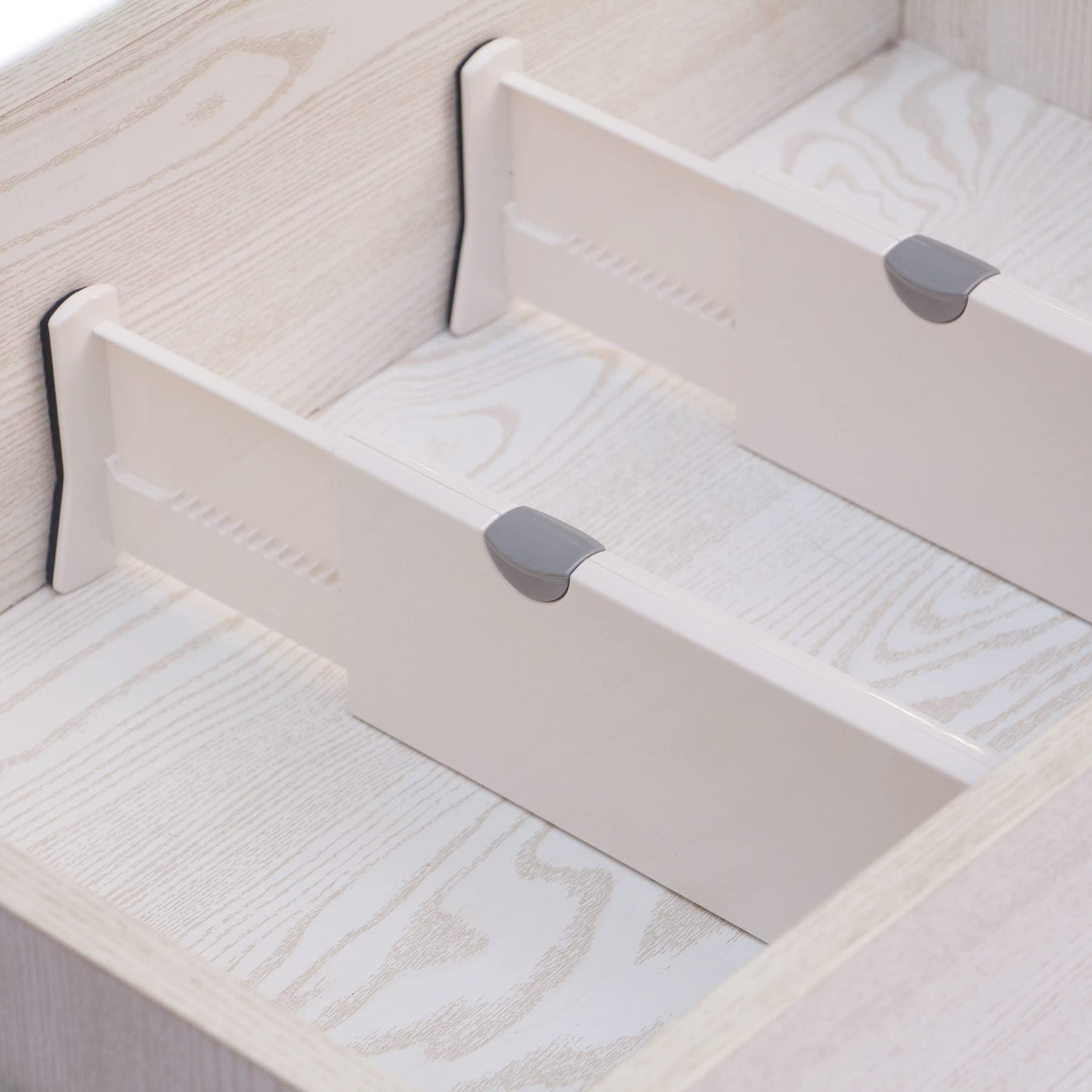 TENABORT divider expanded in drawer creating tidy compartments for utensils
