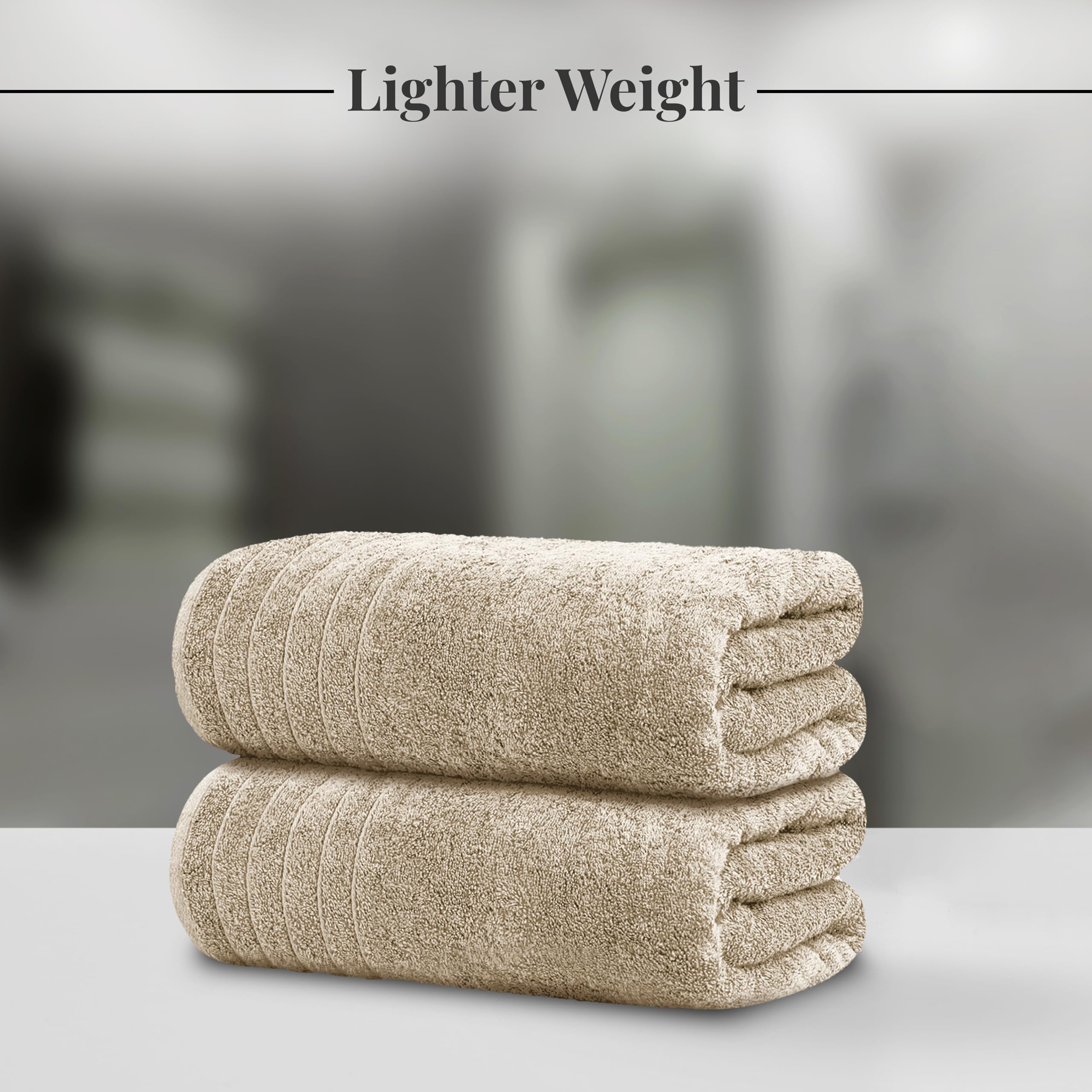 Tens Towels folded stack close-up of cotton texture, showing softness and neat storage