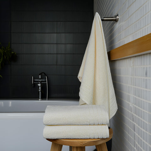 Tens Towels beside ruler showing 30x60 inch size for generous coverage benefit