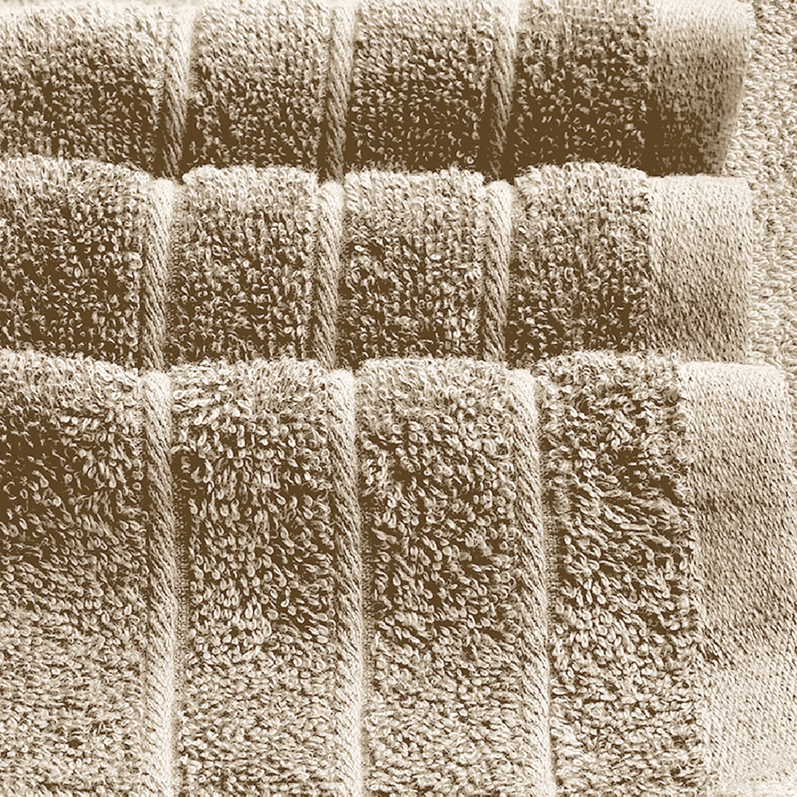 Tens Towels next to a standard towel for scale, showing larger 35x70 inch size