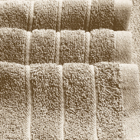 Tens Towels next to a standard towel for scale, showing larger 35x70 inch size
