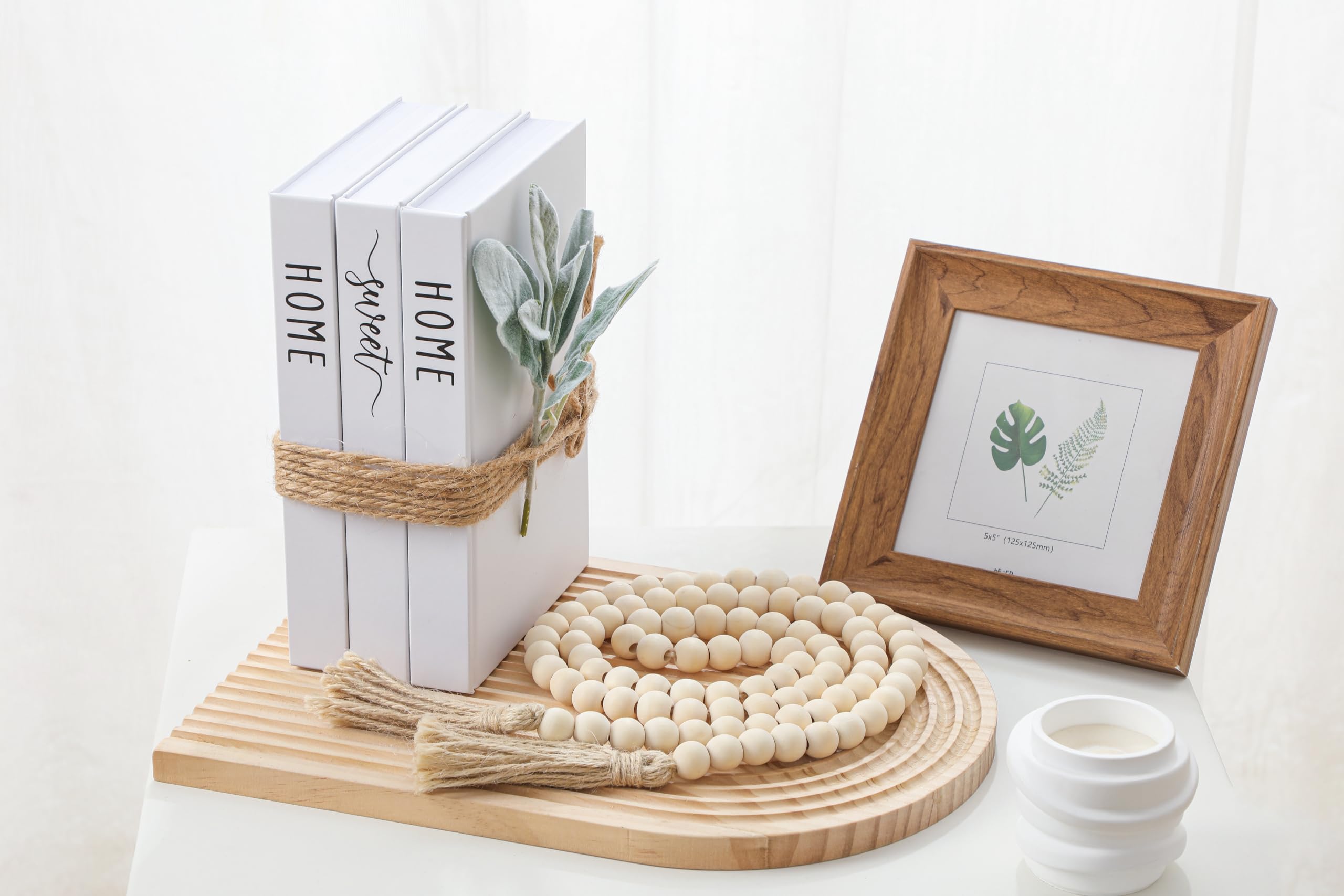 TenXVI Designs stacked books with vase raising decorative height