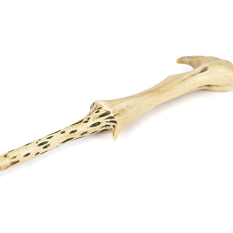 The Noble Collection wand on a shelf in a themed display enhancing collector presentation